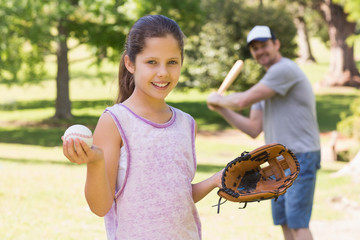 Father and daughter playing baseball