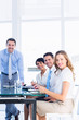 © WavebreakMediaMicro - Executives around conference table in office