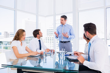 Wall Mural - Executives sitting around conference table