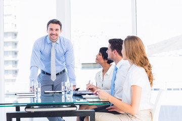 Wall Mural - Executives around conference table in office