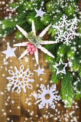 Wall Mural - Beautiful snowflakes with fir branch on wooden background