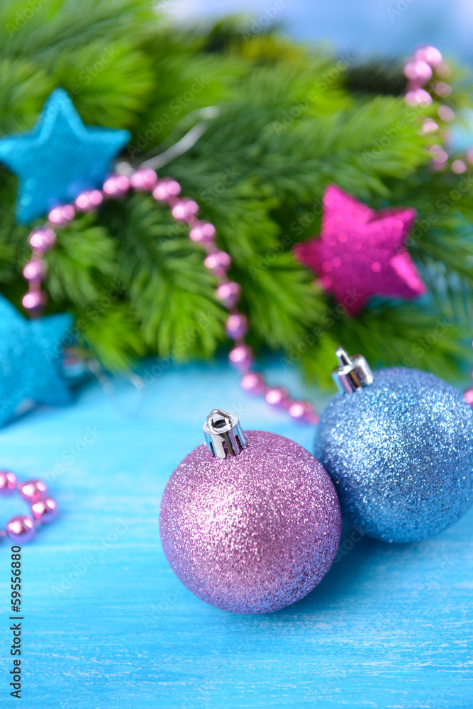 Christmas balls on fir tree, on color background
