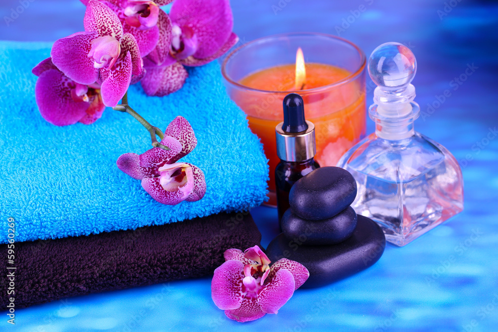 Beautiful spa setting with orchid on blue background