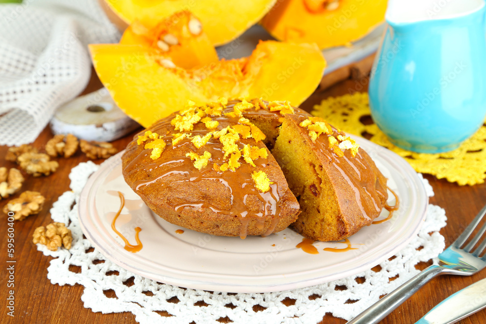 Delicious pumpkin pie on plate on wooden table close-up