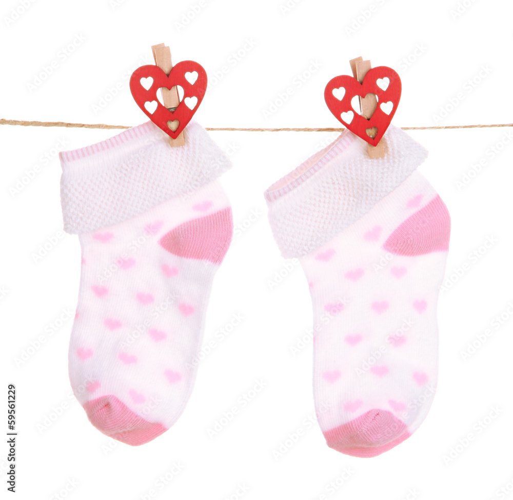 Socks hanging on clothesline isolated on white