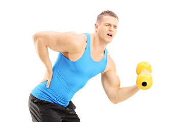 Poster - Young male athlete with back pain lifting a dumbbell