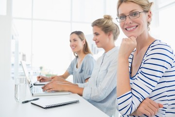 Wall Mural - Three young people working in office