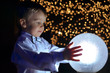 © Grycaj - boy holding a glowing ball.