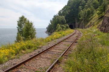 The railway tunnel in a rock on the bank of lake Baikal.