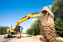 Excavator Unloading Sand During Road Construction Works