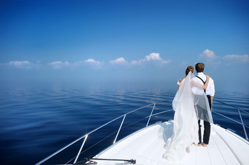 Happy bride and groom on a yacht