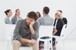 © WavebreakMediaMicro - Therapy in session in circle while man in foreground