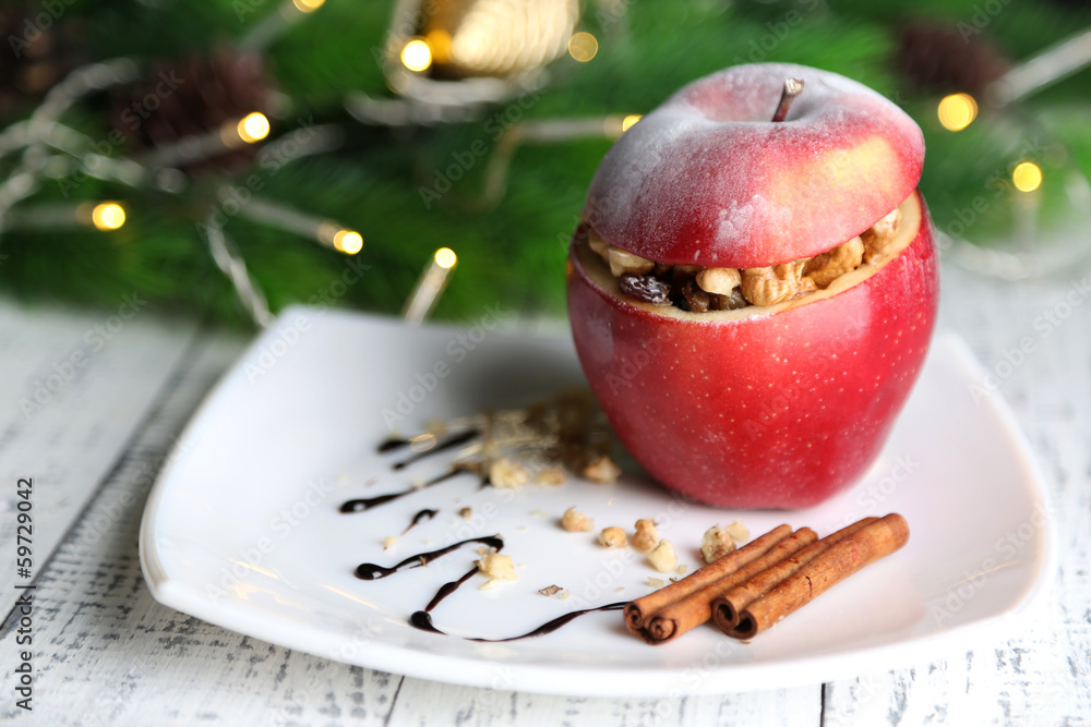 Stuffed Christmas apple with nuts and raisins on table close up