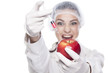 smiling malicious chemist woman injected some liquid in apple
