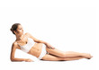 © Acronym - A fit girl in lingerie isolated on a white background