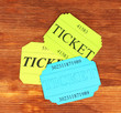 Colorful tickets on wooden background close-up