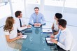 © WavebreakmediaMicro - Executives sitting around conference table