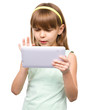 Young nearsighted girl is using tablet