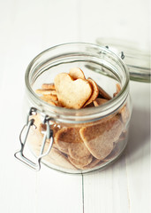 Wall Mural - Jar with Hearts Cookies on white wooden table