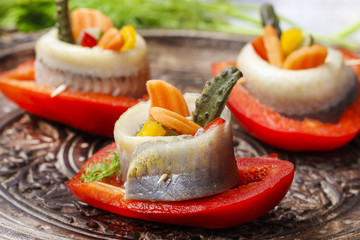 Wall Mural - Pickled herring rolls with vegetables on wooden tray