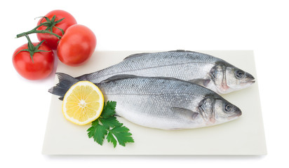 Wall Mural - Fresh sea bass with vegetables on plate isolated on white