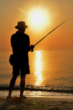 Fisherman Silhouette On The Beach At Colorfull Sunset