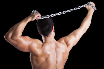 Wall Mural - Muscular young man from back on black background