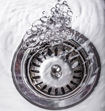 Water Flowing Down The Hole In A Kitchen Sink