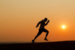 © icsnaps - Sunset silhouette of a man running uphill