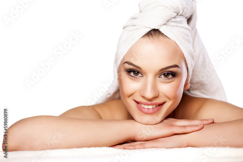 Naklejka na szybę smiling beautiful girl with a towel on her head posing on white