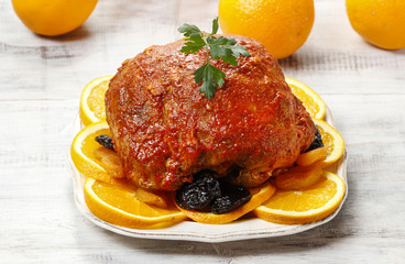 Wall Mural - Pork served on oranges and plums. Festive dinner