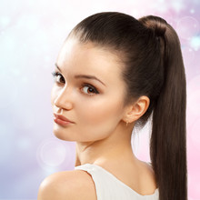 Young Female With Healthy Shining Brown Hairs Put In Pony Tail.