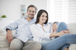 © jackfrog - Couple at home relaxing in sofa