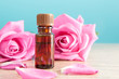 Bottle with aromatic oil and pink rose