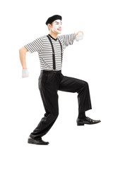 Canvas Print - Full length portrait of male mime artist simulate walk on a rope