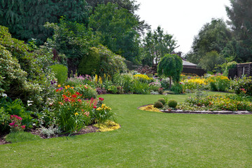 Wall Mural - Green lawn in a colorful landscape formal garden.