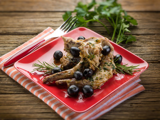 Wall Mural - roasted rabbit with herbs and black olives, selective focus