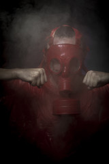 Radioactivity, A man in a gas mask over  the smoke. black backgr