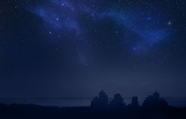 Wall Mural - city landscape at night with star filled sky, nebula and galaxy