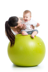 mother playing with baby on fit ball