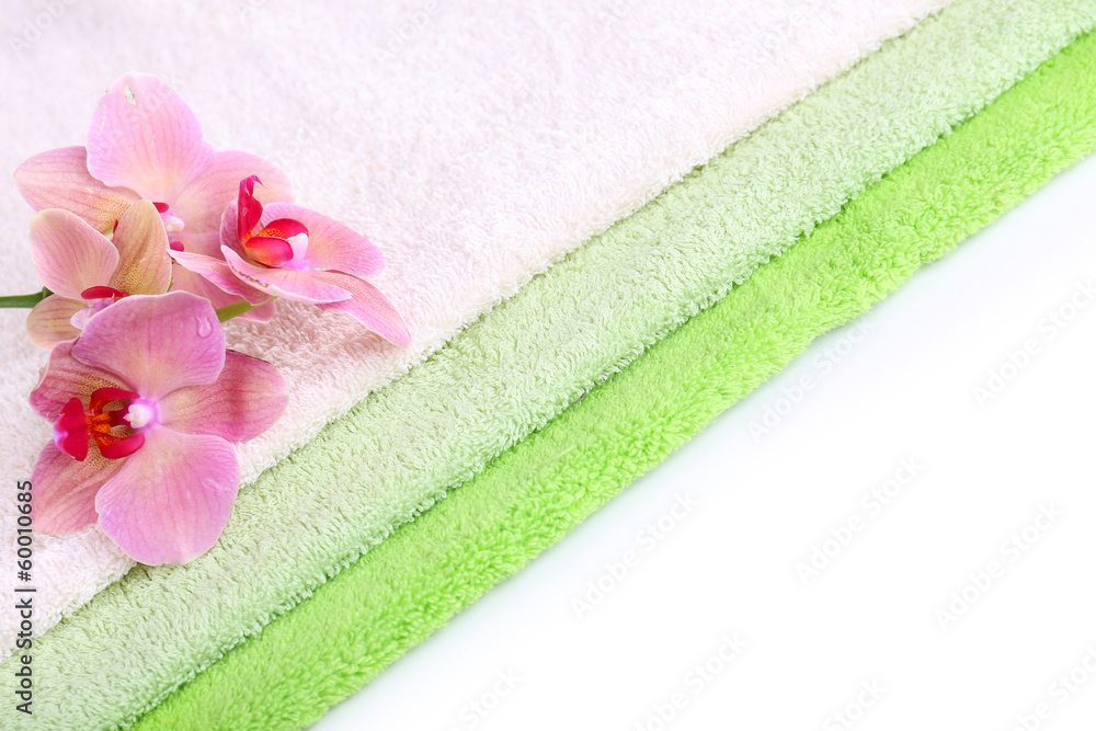 Orchid flower and towels, isolated on white
