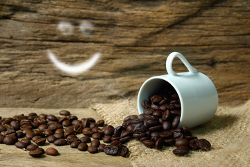 Roasted coffee beans  and smile symbol on grunge wooden  backgro