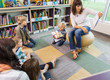 © Tyler Olson - Teacher Reading Book To Children In Library