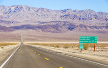 Death Valley Landscape And Road Sign,California