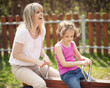 © MDBPIXS - Mother and daughter ride seesaw together