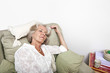 © MDBPIXS - Tired senior woman sleeping on armchair at home