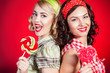 © A.Kazak - Beautiful pinup girls with lollipop on red background