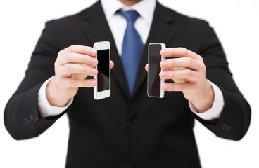 Wall Mural - businessman showing smartphones with blank screens