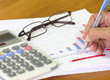 © Tawanboonnak - Finance budget report with hand of someone