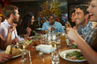 © Monkey Business - Group Of Friends Enjoying Meal In Restaurant